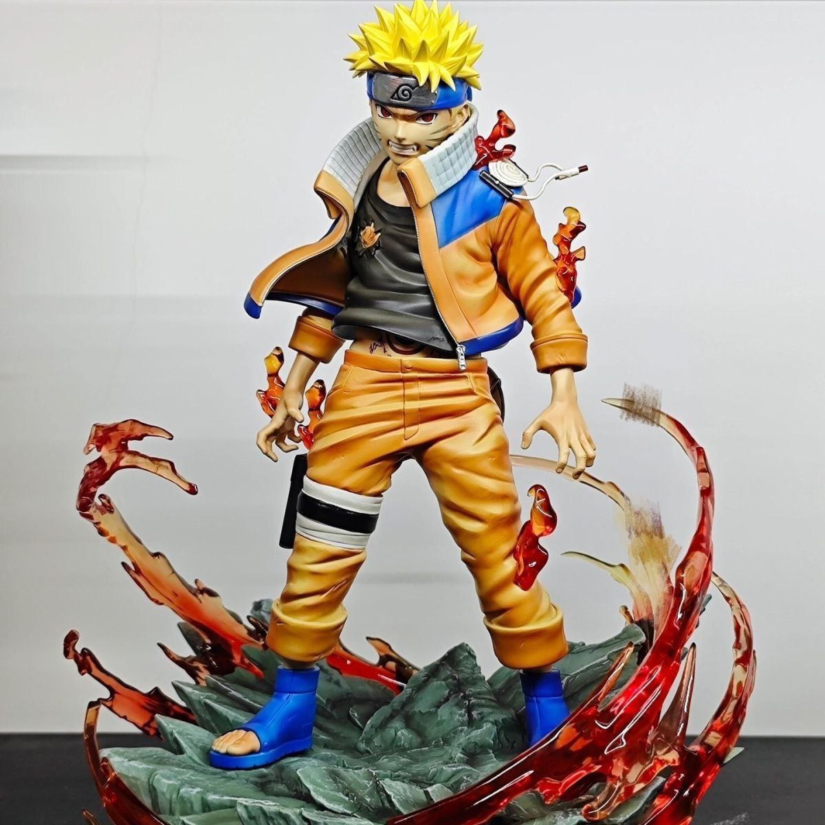 Naruto figurines, including the final battle scene from the Valley of the End, featuring Naruto as a statue, model, and anime character.Naruto figurines, including the final battle scene from the Valley of the End, featuring Naruto as a statue