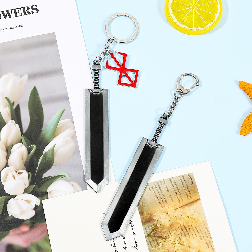 Berserk keychain, red and black, featuring the Black Swordsman Guts' weapon, a decorative pendant.